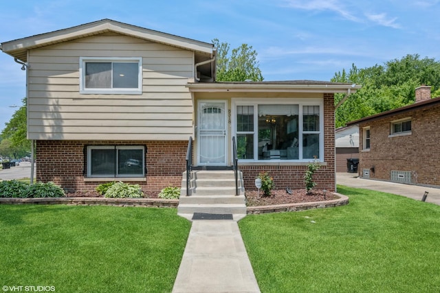 8518 S Avalon Ave, Chicago, IL 60619 - tri-level home with a front yard and brick siding