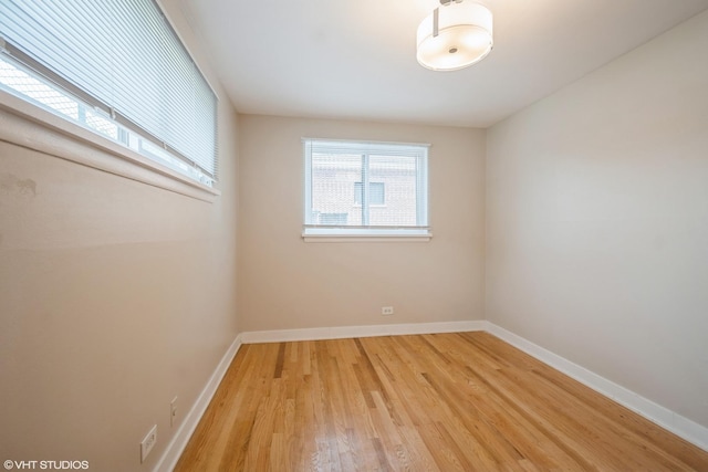 8518 S Avalon Ave, Chicago, IL 60619 - spare room with light wood-style flooring and baseboards