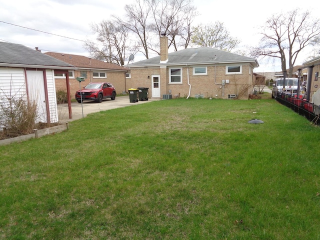 4603 Rose St, Schiller Park, IL 60176 - back of house featuring a yard and a chimney