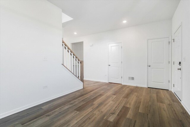 908 Fair Meadow St, North Aurora, IL 60542 - dining room with wallpapered walls, an accent wall, stairs, wood finished floors, and recessed lighting