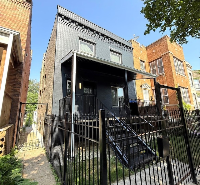 7042 S Eberhart Ave, Chicago, IL 60637 - multi unit property with brick siding, a fenced front yard, stairs, and a gate