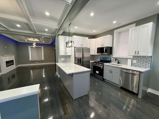 7042 S Eberhart Ave, Chicago, IL 60637 - kitchen with stainless steel appliances, backsplash, a peninsula, light stone counters, and dark wood-style floors