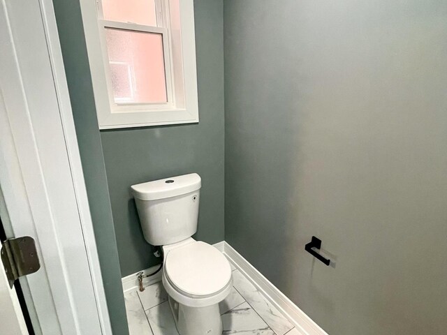 7042 S Eberhart Ave, Chicago, IL 60637 - bathroom with marble look tile flooring and baseboards