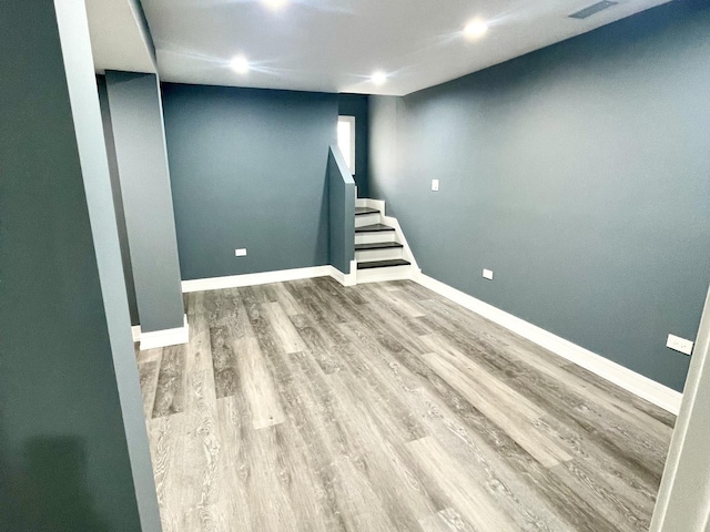 7042 S Eberhart Ave, Chicago, IL 60637 - finished below grade area featuring wood finished floors, stairway, and recessed lighting