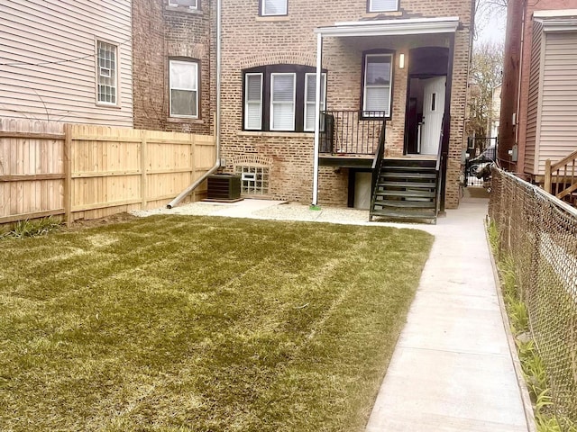 7042 S Eberhart Ave, Chicago, IL 60637 - back of property with brick siding and a fenced backyard