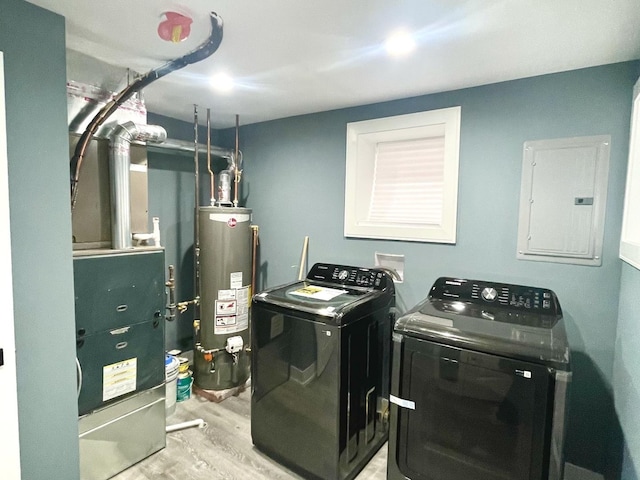 7042 S Eberhart Ave, Chicago, IL 60637 - laundry room with water heater, electric panel, separate washer and dryer, and light wood-style flooring