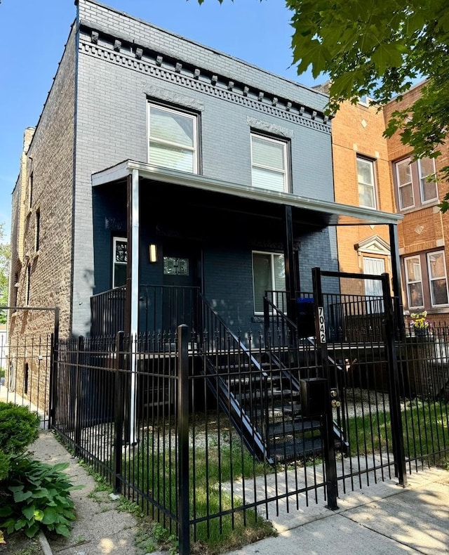7042 S Eberhart Ave, Chicago, IL 60637 - view of front of house featuring brick siding and a fenced front yard