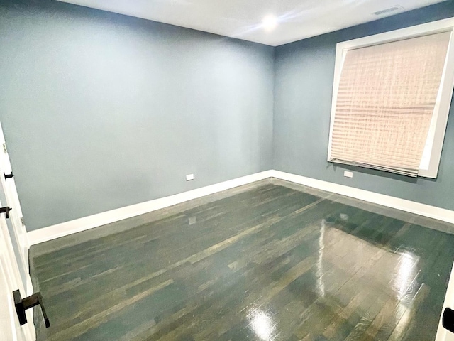 7042 S Eberhart Ave, Chicago, IL 60637 - empty room featuring baseboards and wood finished floors