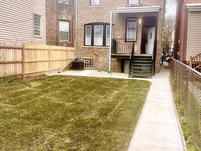 7042 S Eberhart Ave, Chicago, IL 60637 - back of property with brick siding and a fenced backyard