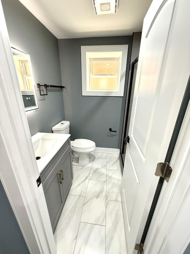7042 S Eberhart Ave, Chicago, IL 60637 - bathroom featuring vanity and marble finish flooring
