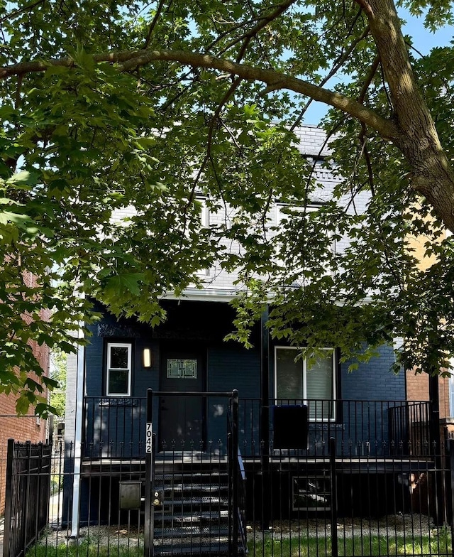 7042 S Eberhart Ave, Chicago, IL 60637 - obstructed view of property with a fenced front yard and brick siding