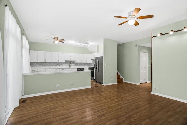 unfurnished living room featuring ceiling fan, dark wood finished floors, a sink, stairway, and baseboards