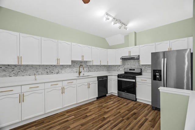 kitchen with appliances with stainless steel finishes, a sink, under cabinet range hood, white cabinets, and track lighting