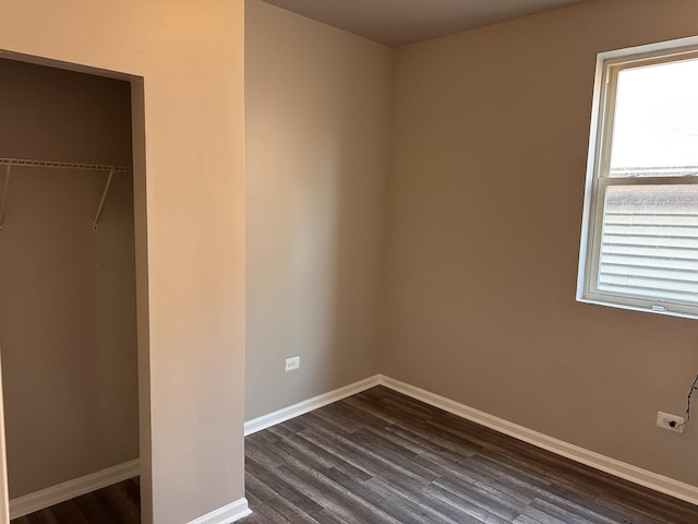 4107 W 16th St, Chicago, IL 60623 - unfurnished bedroom featuring dark wood-style flooring, baseboards, and a closet