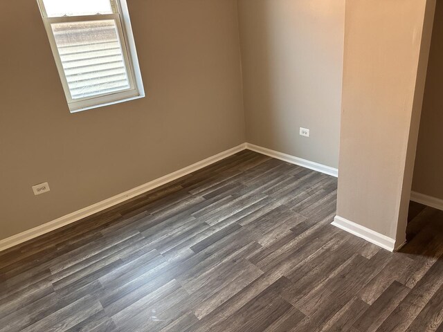 4107 W 16th St, Chicago, IL 60623 - spare room with baseboards and dark wood-type flooring