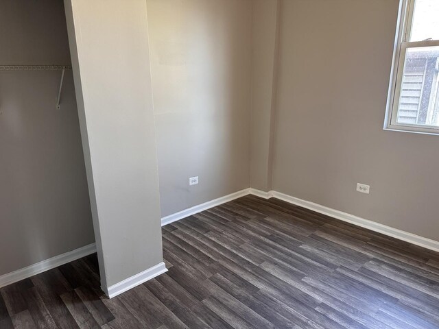 4107 W 16th St, Chicago, IL 60623 - unfurnished bedroom featuring dark wood-style floors and baseboards