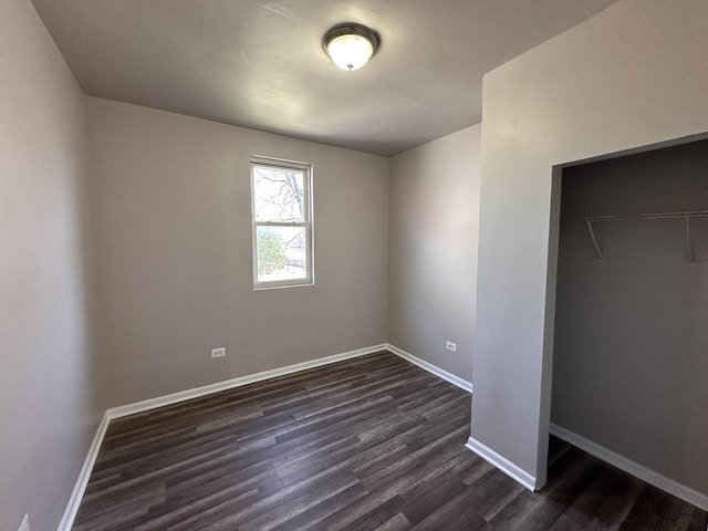 4107 W 16th St, Chicago, IL 60623 - unfurnished bedroom with dark wood finished floors, baseboards, and a closet