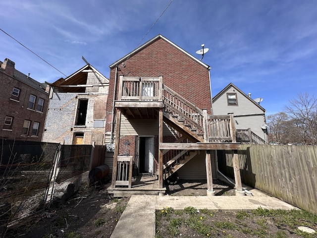 4107 W 16th St, Chicago, IL 60623 - rear view of house with stairs, a wooden deck, fence, and brick siding