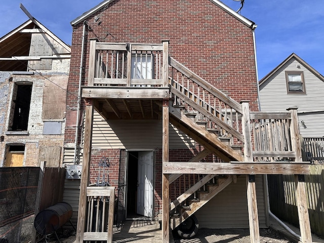4107 W 16th St, Chicago, IL 60623 - rear view of property with stairs, brick siding, and a wooden deck