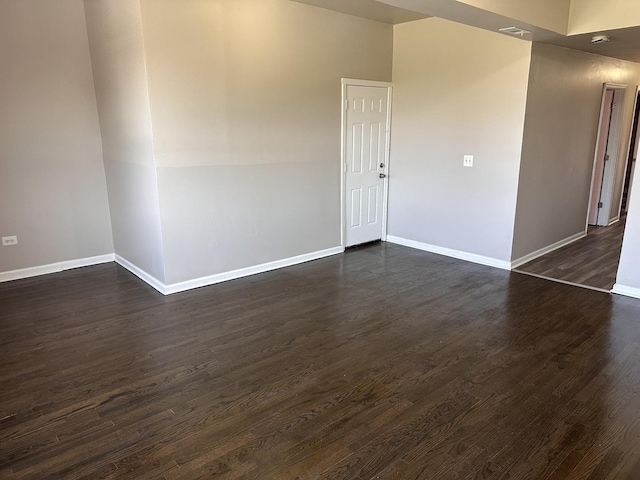 4107 W 16th St, Chicago, IL 60623 - spare room with baseboards and dark wood-type flooring