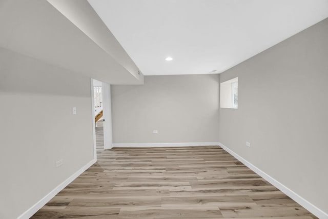 basement featuring recessed lighting, baseboards, and wood finished floors