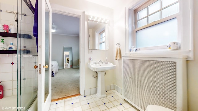 2335 N Commonwealth Ave Unit 2G, Chicago, IL 60614 - bathroom with baseboards, a sink, a shower with shower door, and ornamental molding