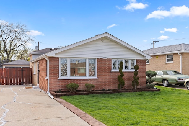 bungalow featuring brick siding, fence, and a front yard