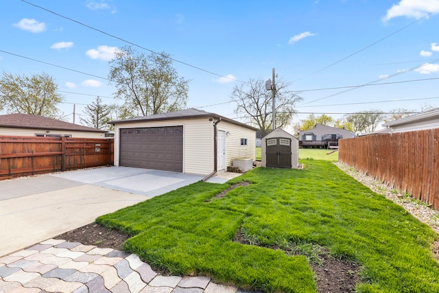 view of yard featuring an outdoor structure, fence, and a detached garage