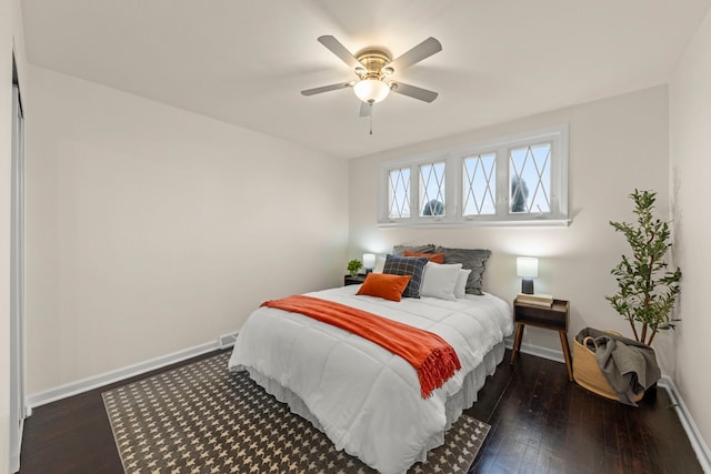 bedroom featuring baseboards, a ceiling fan, and dark wood finished floors