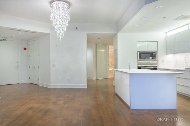 kitchen featuring modern cabinets, stainless steel oven, and built in microwave