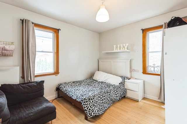 3449 N Oak Park Ave, Chicago, IL 60634 - bedroom featuring light wood-style flooring, baseboards, and multiple windows