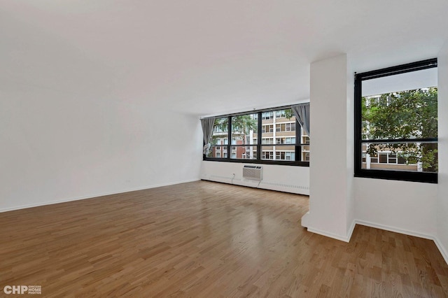 33 E Cedar St Unit 3H, Chicago, IL 60611 - empty room featuring wood finished floors and a wall unit AC