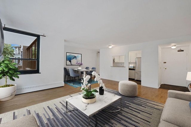 33 E Cedar St Unit 3H, Chicago, IL 60611 - living area featuring a baseboard radiator and wood finished floors