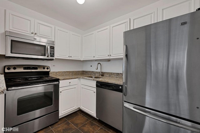 33 E Cedar St Unit 3H, Chicago, IL 60611 - kitchen featuring stainless steel appliances, white cabinets, and light stone countertops