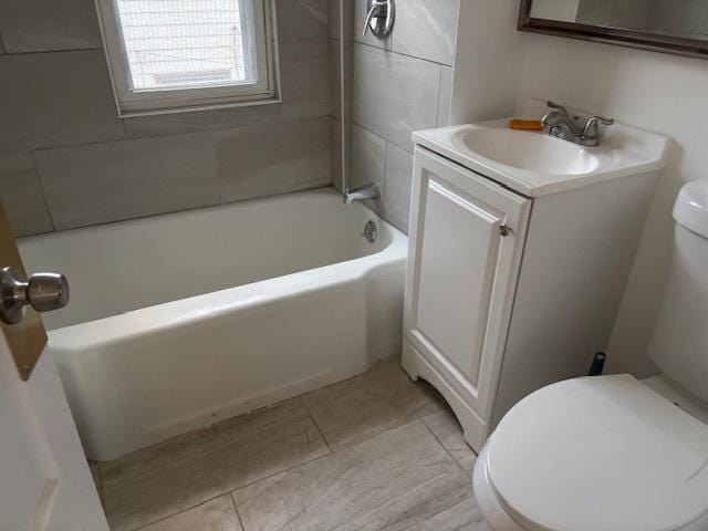 bathroom featuring toilet, vanity, and tile patterned floors