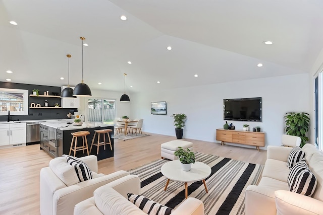 living area with recessed lighting, light wood finished floors, and lofted ceiling
