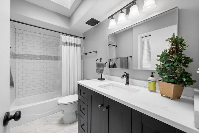 bathroom with vanity, toilet, marble finish floor, shower / tub combo, and a skylight