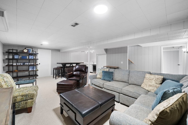 living room featuring visible vents and carpet