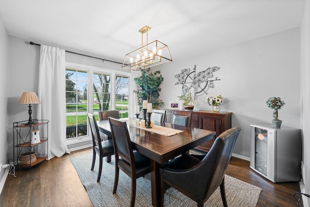 dining space with baseboards, a notable chandelier, dark wood-style floors, and wine cooler