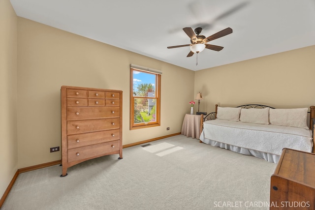 carpeted bedroom with baseboards, ceiling fan, and visible vents