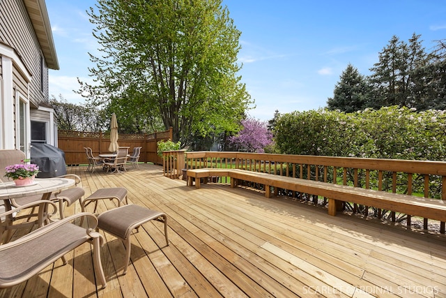 deck featuring outdoor dining area and grilling area