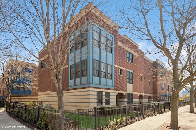 view of building exterior with a fenced front yard