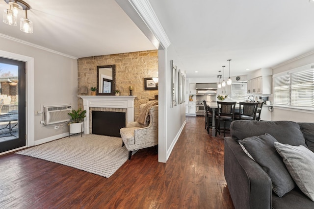 353 E Butterfield Rd, Elmhurst, IL 60126 - living area featuring a wall mounted AC, ornamental molding, a fireplace, dark wood-style flooring, and baseboards