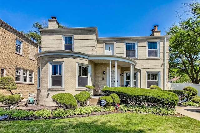 5801 N Drake Ave, Chicago, IL 60659 - view of front of house featuring a chimney, fence, and brick siding