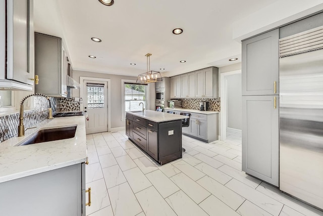 5801 N Drake Ave, Chicago, IL 60659 - kitchen featuring a sink, built in refrigerator, recessed lighting, gray cabinets, and backsplash