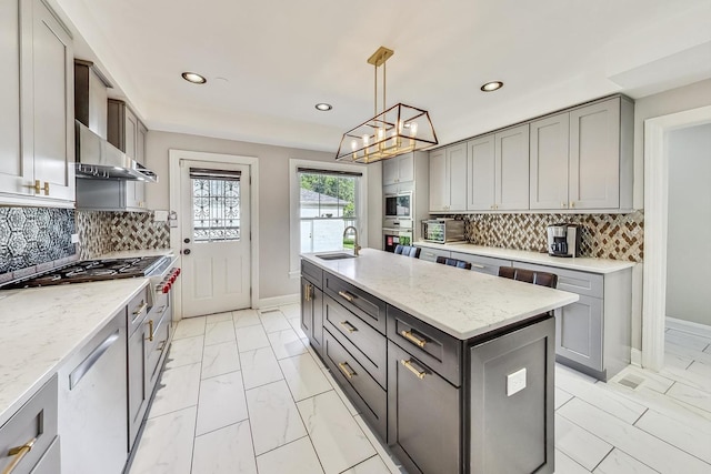 5801 N Drake Ave, Chicago, IL 60659 - kitchen with gray cabinets, a sink, and baseboards