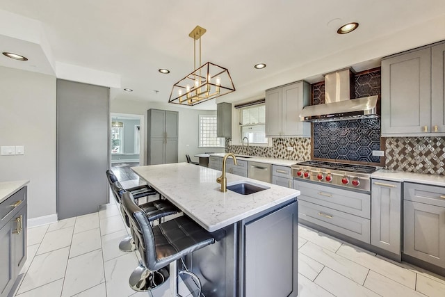 5801 N Drake Ave, Chicago, IL 60659 - kitchen featuring wall chimney exhaust hood, stainless steel gas stovetop, light stone counters, a sink, and gray cabinetry
