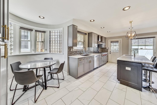 5801 N Drake Ave, Chicago, IL 60659 - kitchen with a sink, gray cabinets, recessed lighting, and wall chimney range hood