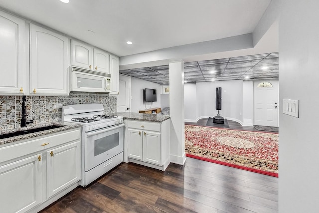 5801 N Drake Ave, Chicago, IL 60659 - kitchen featuring white appliances, white cabinets, recessed lighting, a sink, and dark wood-style floors