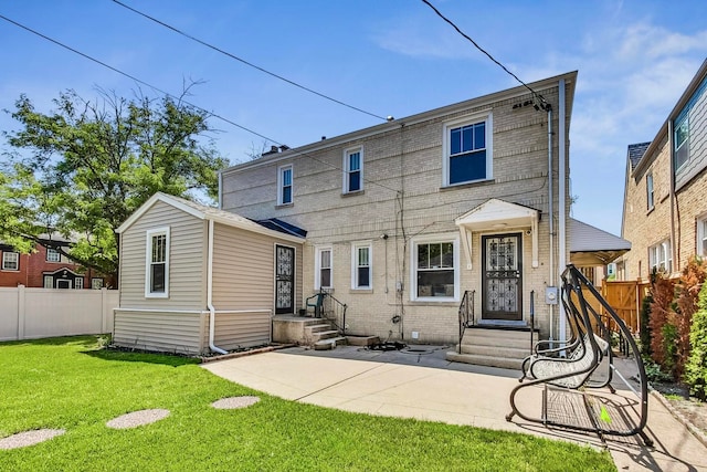 5801 N Drake Ave, Chicago, IL 60659 - back of property featuring entry steps, brick siding, fence, and a lawn